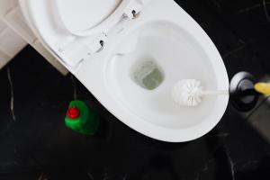 A toilet being cleaned